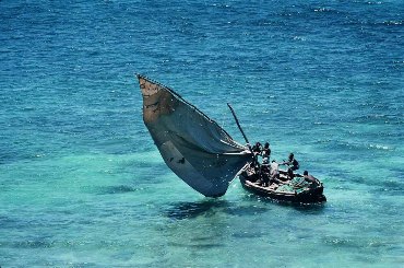 This photo of Mozambique fishermen hard at work off the Island of Mozambique (Ilha de Mocambique) was taken by Steve Evans of Bangalore, India and is used courtesy of the Creative Commons Attribution 2.0 License. (http://commons.wikimedia.org/wiki/File:Mozambique_-_traditional_sailboat.jpg)